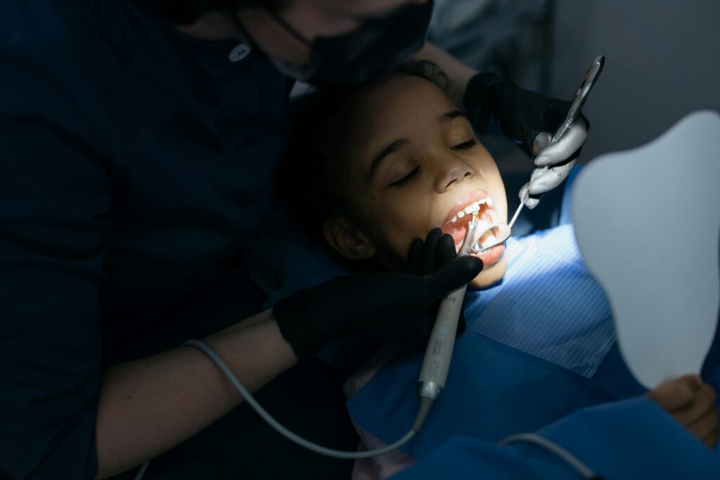 pexels-photo-6502555-6502555 A young girl receiving a dental checkup at a clinic, highlighting oral care.